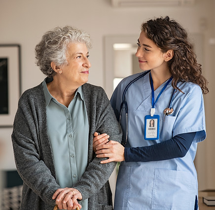 Young caregiver helping senior woman walking Nurse assisting her old woman patient at nurs