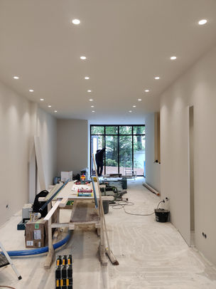 Amsterdam facial clinic interior design featuring sculptural reception desk, modern testing bar, calming color palette, and luxury treatment-focused layout.