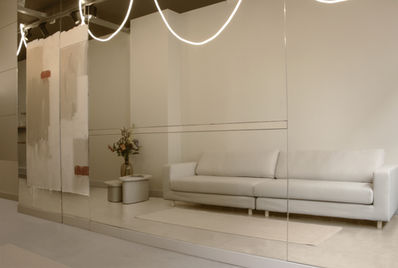 Amsterdam commercial interior design for facial clinic featuring minimalist layout, bespoke mirror wall artwork, and modern treatment spaces in historic city center.