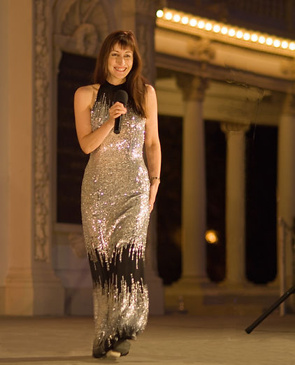 Dr. Carol wears a sexy silver dress