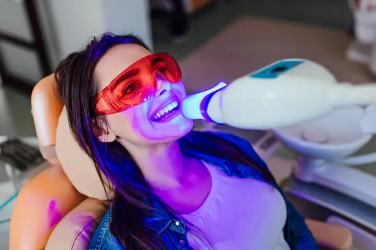 Confident woman smiling after teeth whitening treatment