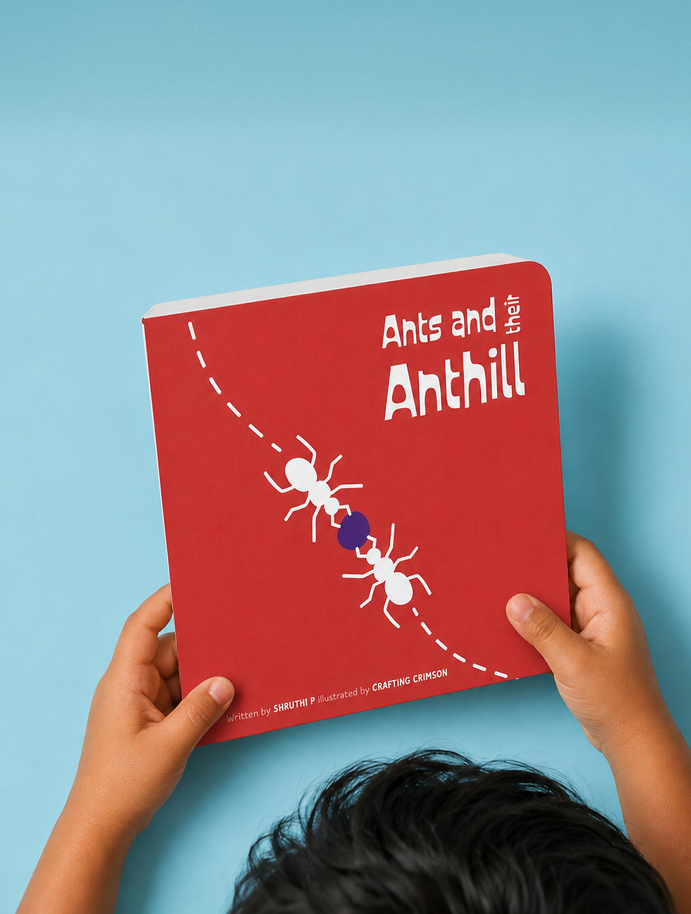 Kid holding ant book
