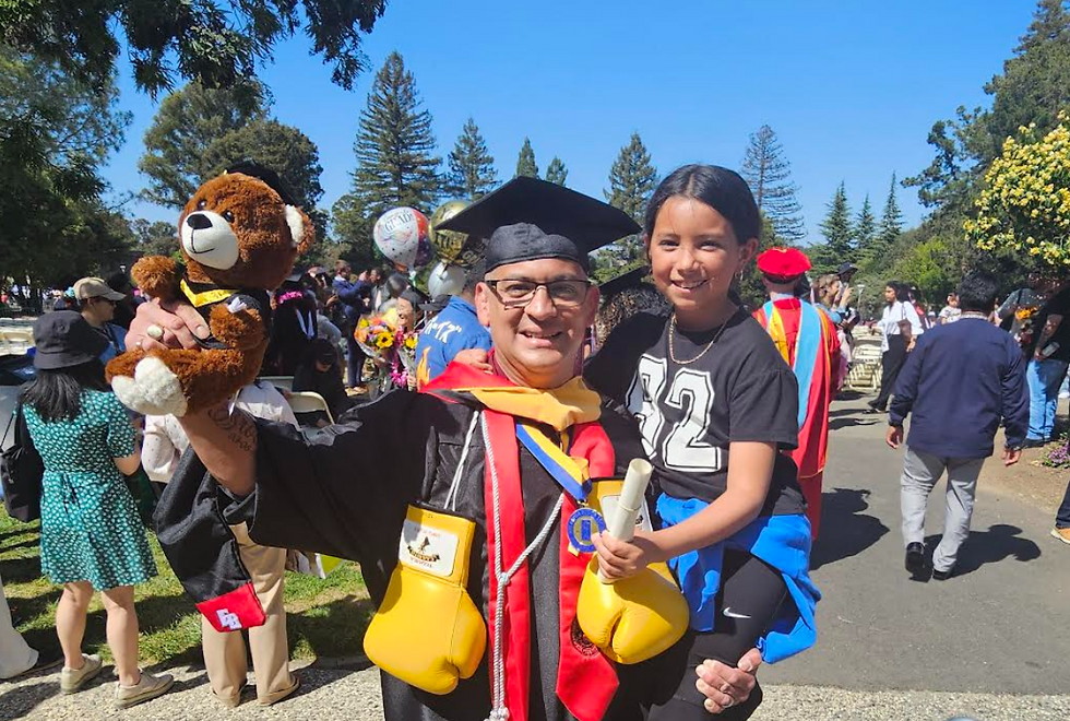 Manny stands proud at his graduation