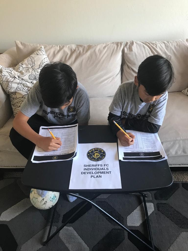 Boys at home working on their Individual Development Plans.