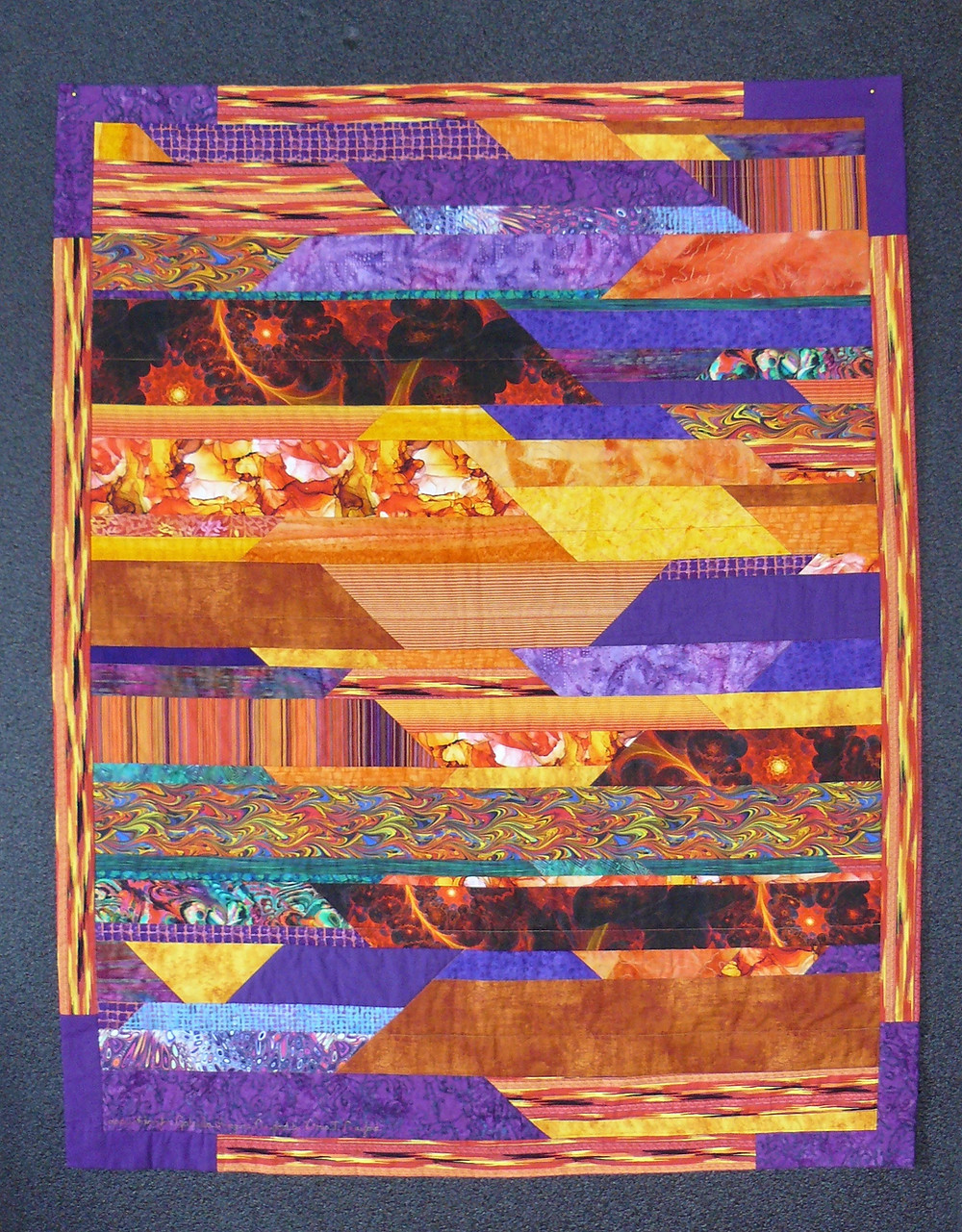 Quilt in oranges and purple bands