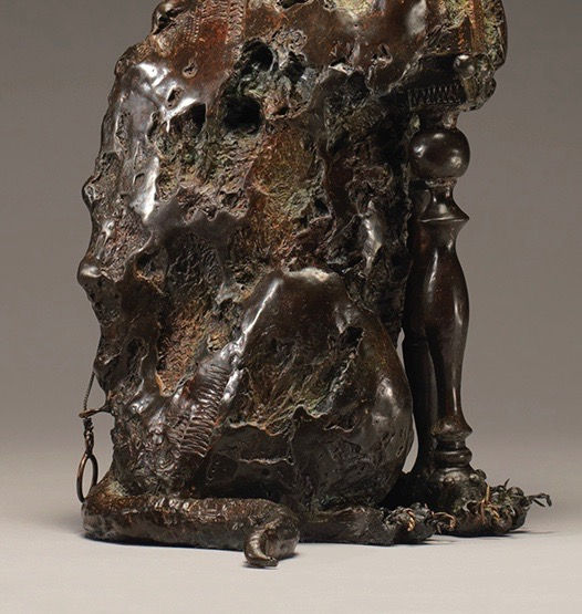 Details of the barbed-wire claws of a bronze cat sculpture.
