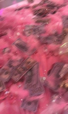 blurry image of money on a pink fluffy surface