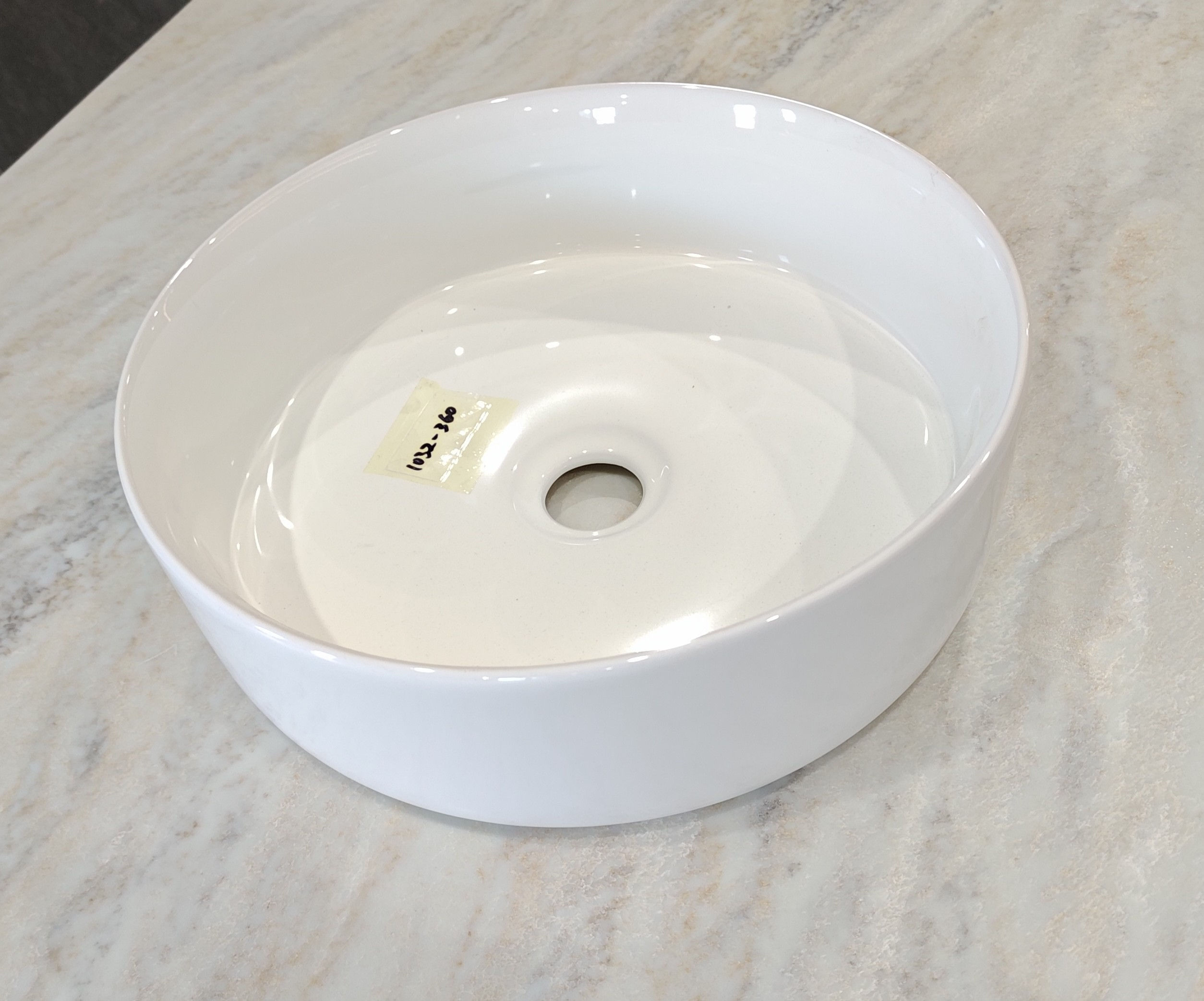 White Cloud Curve Basin on a marble countertop