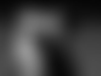 A father with dark curly hair & a beard kissing his baby son on the cheek