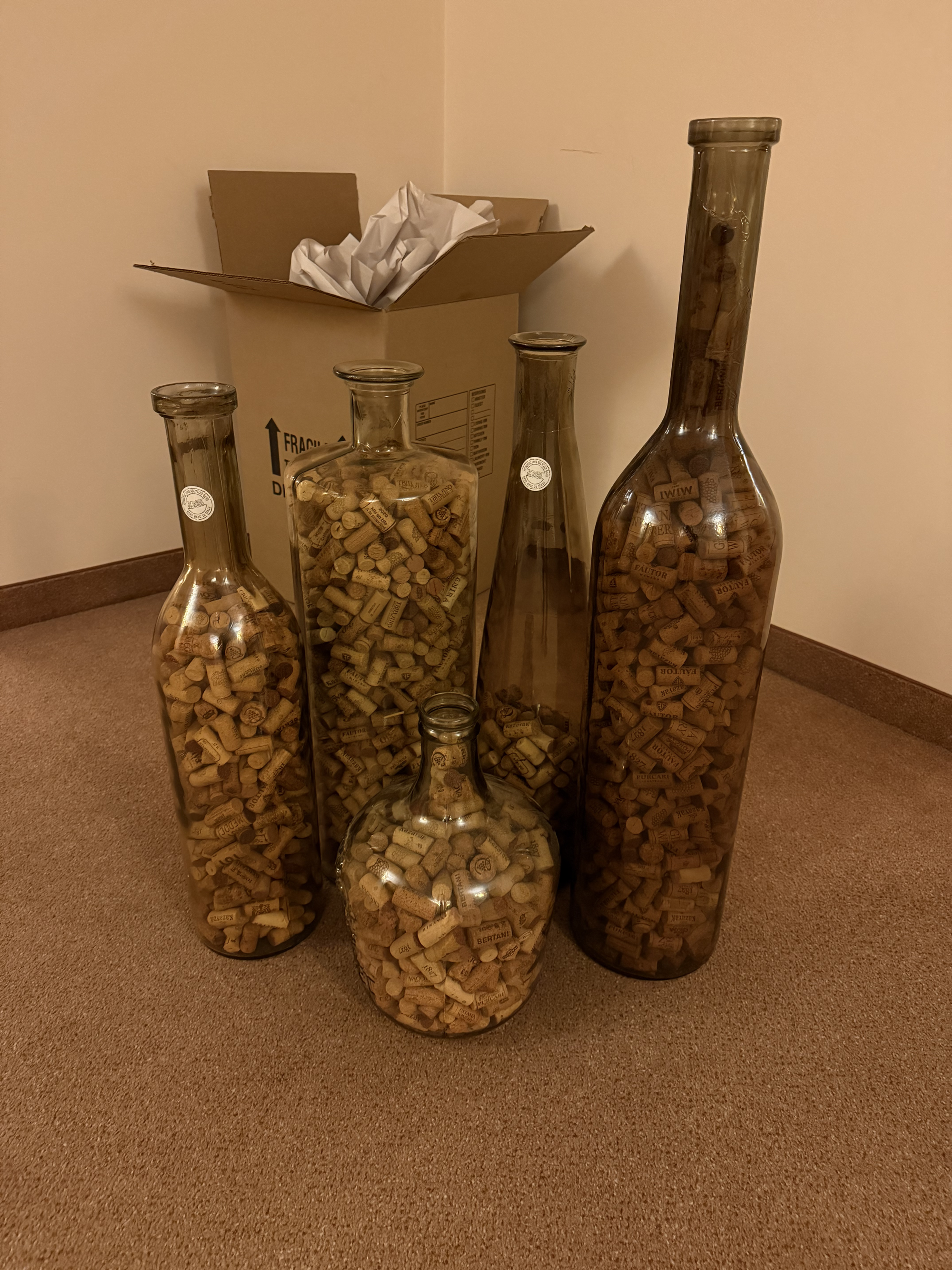 Lot of decorative glass carafes filled with wine corks