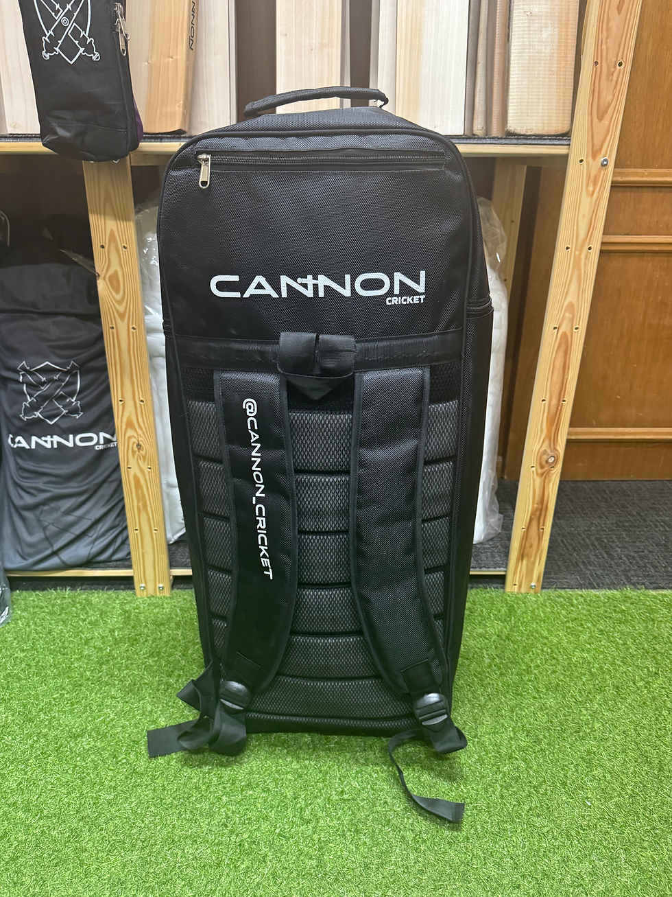 Thumbnail: Black Cannon Cricket backpack with logo and shoulder straps on green grass