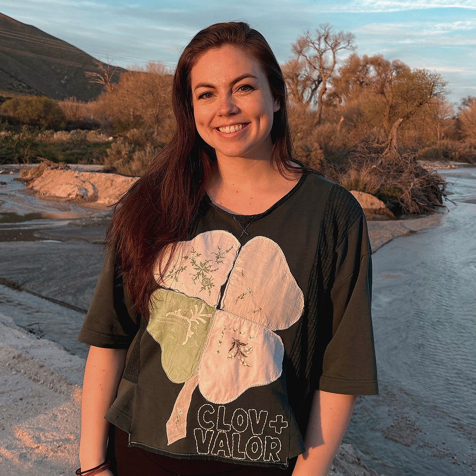 Erika, founder of Clov and Valor in a clover t-shirt by a stream