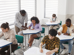 teacher helping students in exam hall