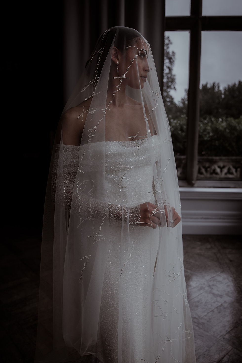 Bride wearing an embroidered script wedding veil with handwriting-inspired detailing, styled in a soft Cloud Dancer white palette; personalised veil photography for 2026 wedding trends.