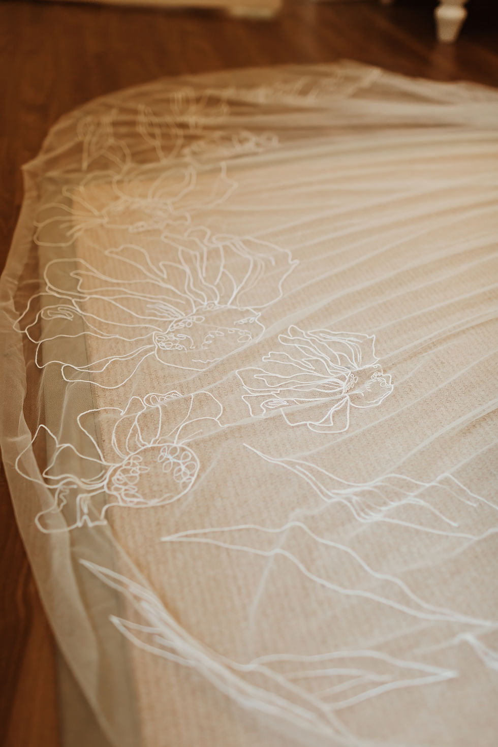 Close-up of large-scale embroidery on a custom wedding veil, illustrating intricate craftsmanship and factors that influence how much do wedding veils cost