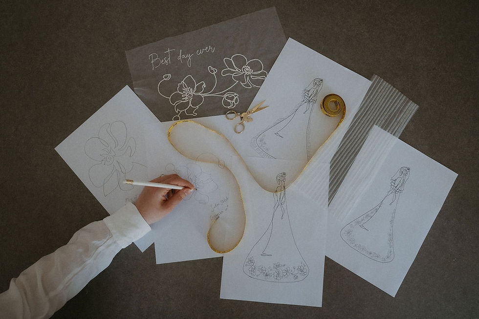 Flatlay of veil design sketches and lace embroidery samples — insight into lace veil trends for 2026.