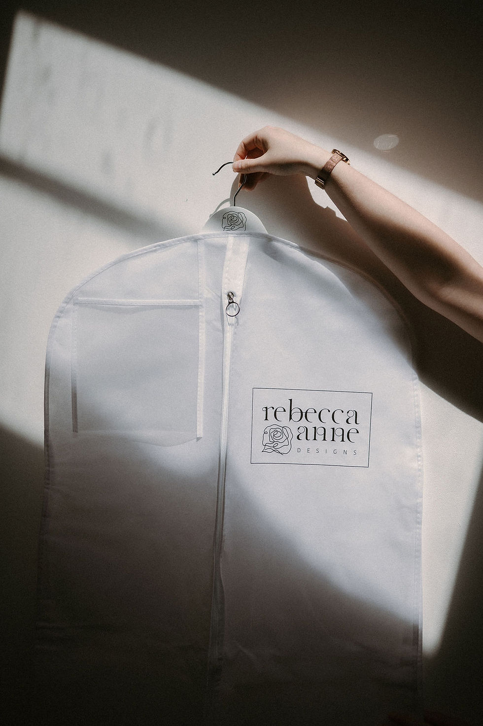 Rebecca Anne Designs veil bag shown hanging on a custom hanger – designed to protect your veil as part of thoughtful veil care.