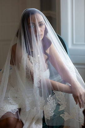 Bride wearing an embroidered lace veil with floral lace detail across the tulle