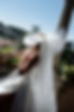 ride outdoors wearing oversized bridal hair bow with long tulle veil tails, modern wedding veil alternative with statement bow