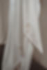 Close-up of personalised embroidered bridal ribbon with floral line art and script detail on satin fabric