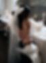 Bride wearing short wedding veil with tulle bow detail at back, modern bridal veil styling with soft volume