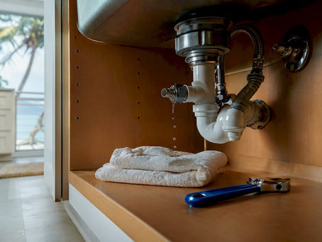 Active leak beneath a kitchen sink cabinet