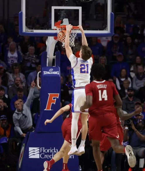 Charles Bediako (14) can only watch as Alex Condon dunks (Photo courtesy of UAA Communications)