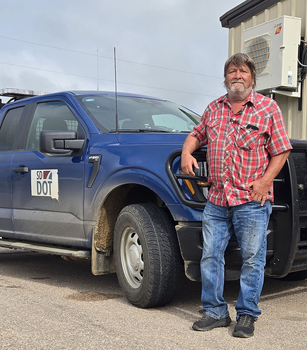 Joel Larson, Heart of the Township, leans against his SD DOT truck — a man who’s spent nearly 40 years keeping Rainbow Township’s roads in shape.