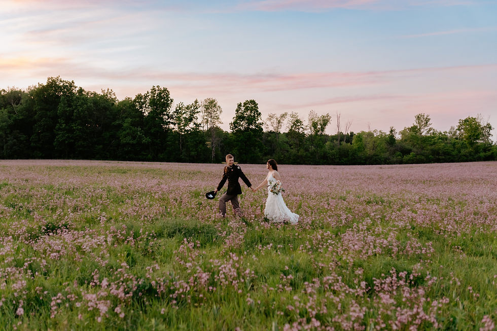 bride and groom in a field