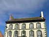 Georgian-style building with green window trim