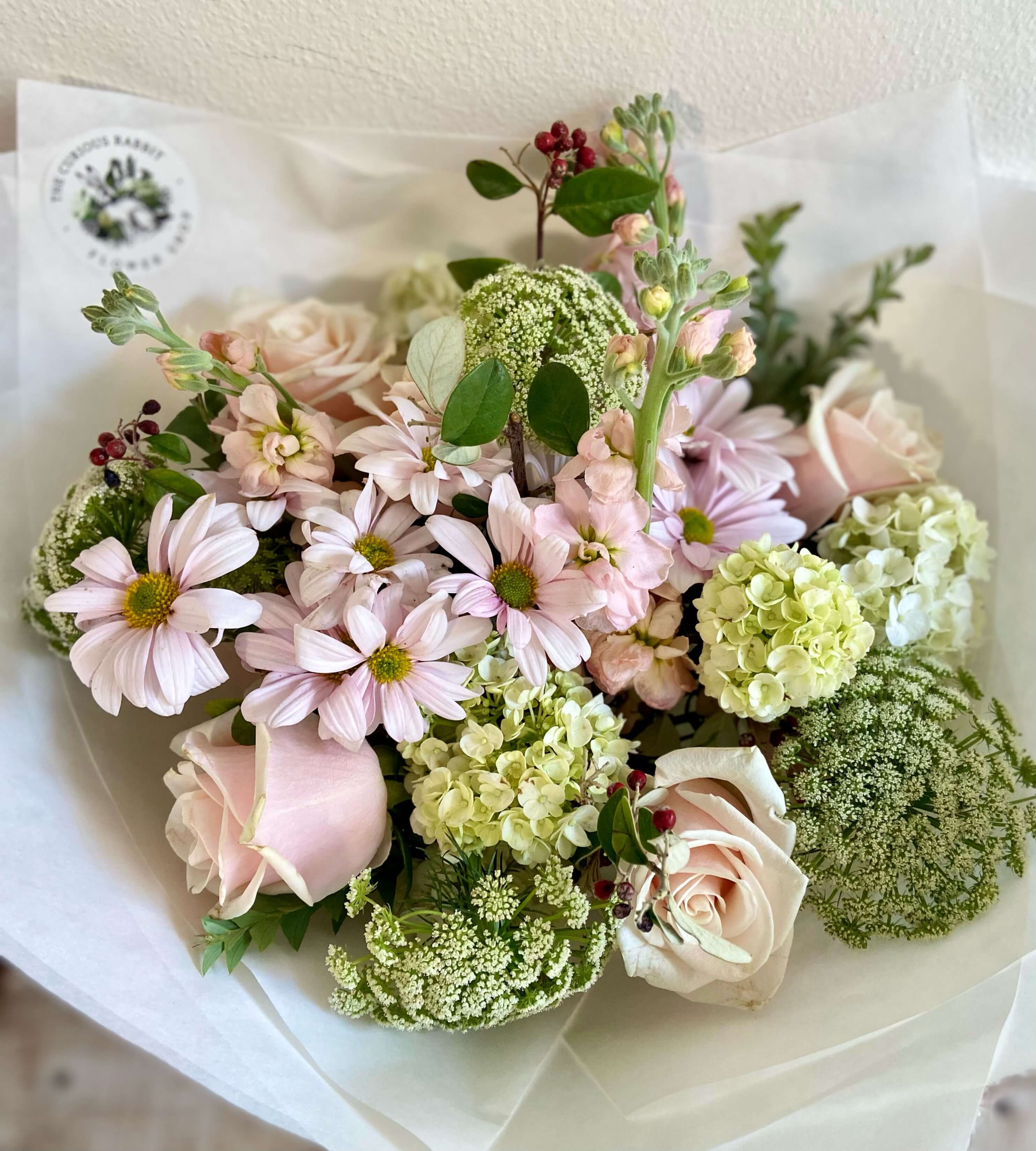 Vintage charm seasonal flower bouquet in pinks, whites, creams, mauves and green foliage