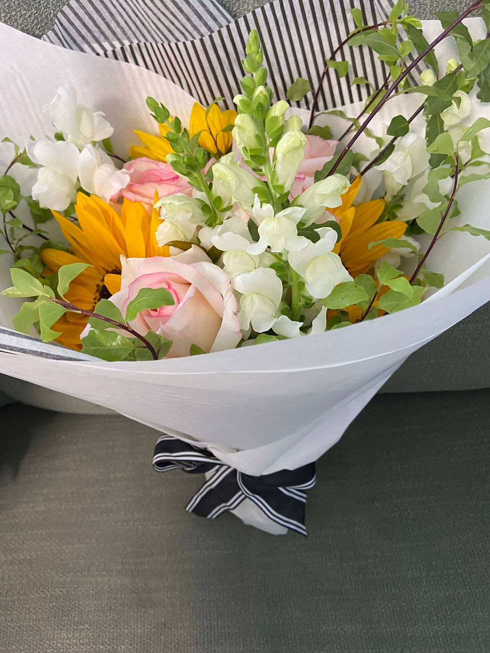 Pet friendly bouquet from The Curious Rabbit Flower Shop, containing pink roses, sunflowers, snapdragons & pittosporum