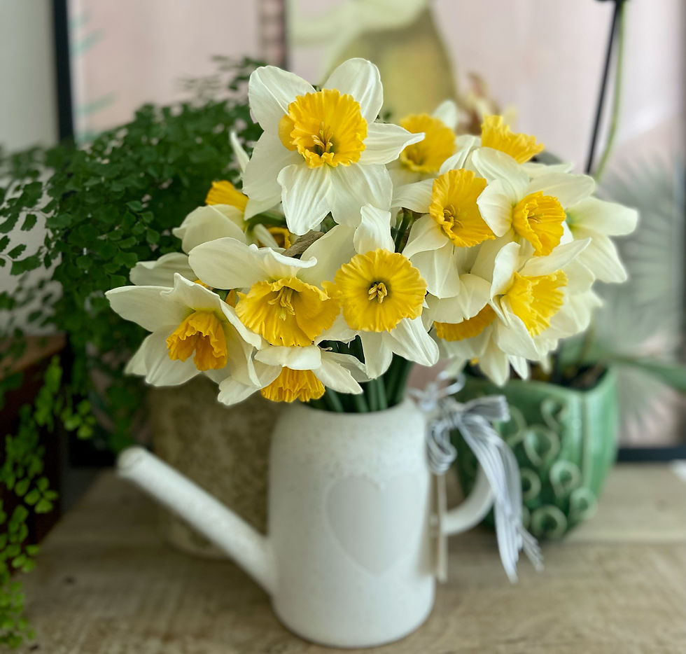 A bunch of seasonal daffodils in a unique watering can.
