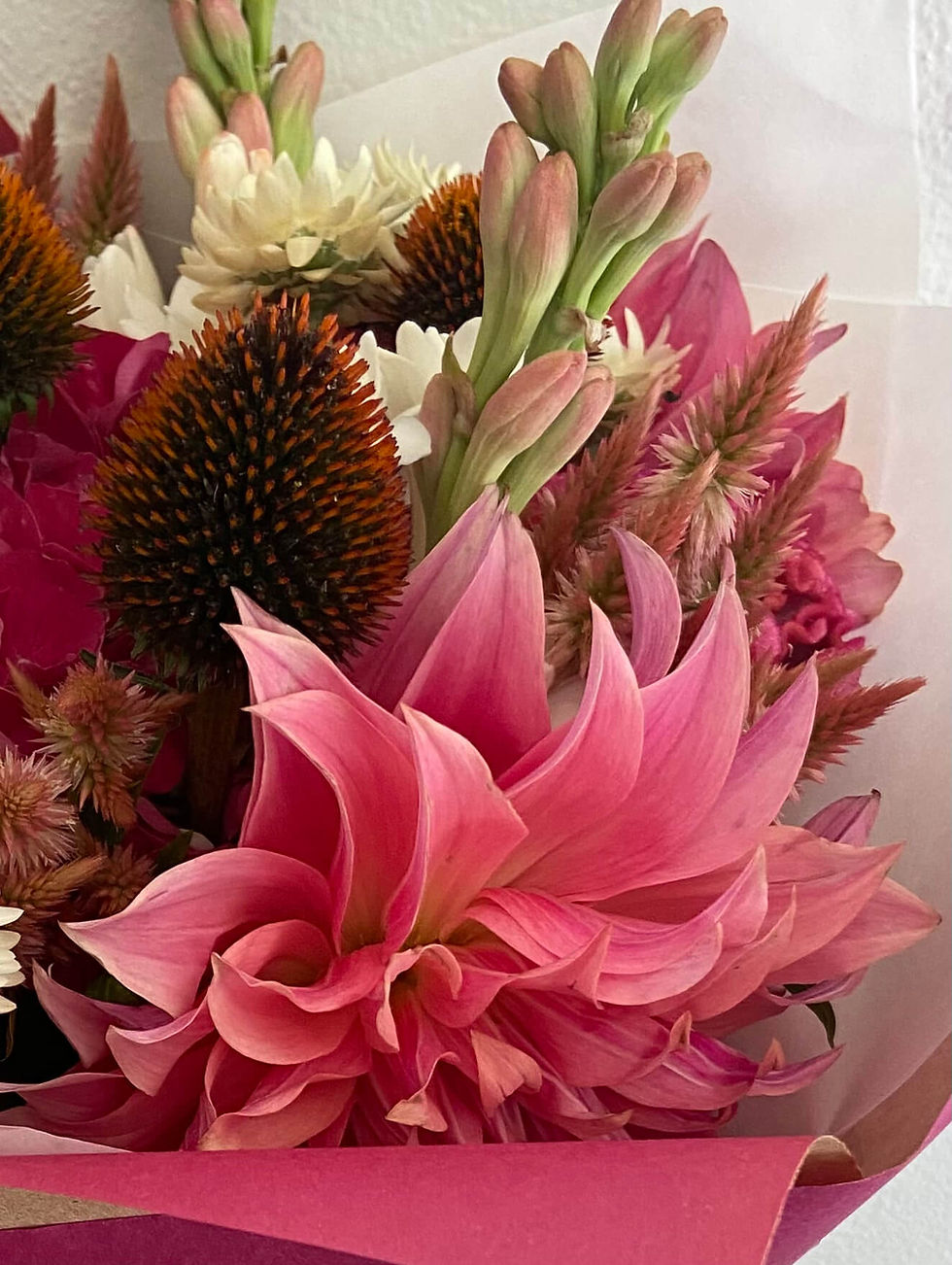 Deep shades of pink dahlias and celosia with tuberose and echinacea. 