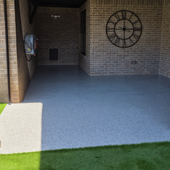 Epoxy flake floor installation in Abilene, Texas featuring a light gray textured surface with black and white flakes