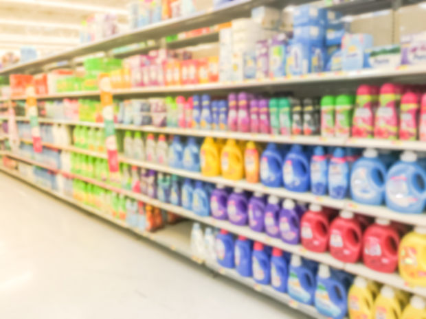 Blurred abstract bleach, fabric softener, laundry detergent, all purpose cleaners shelves