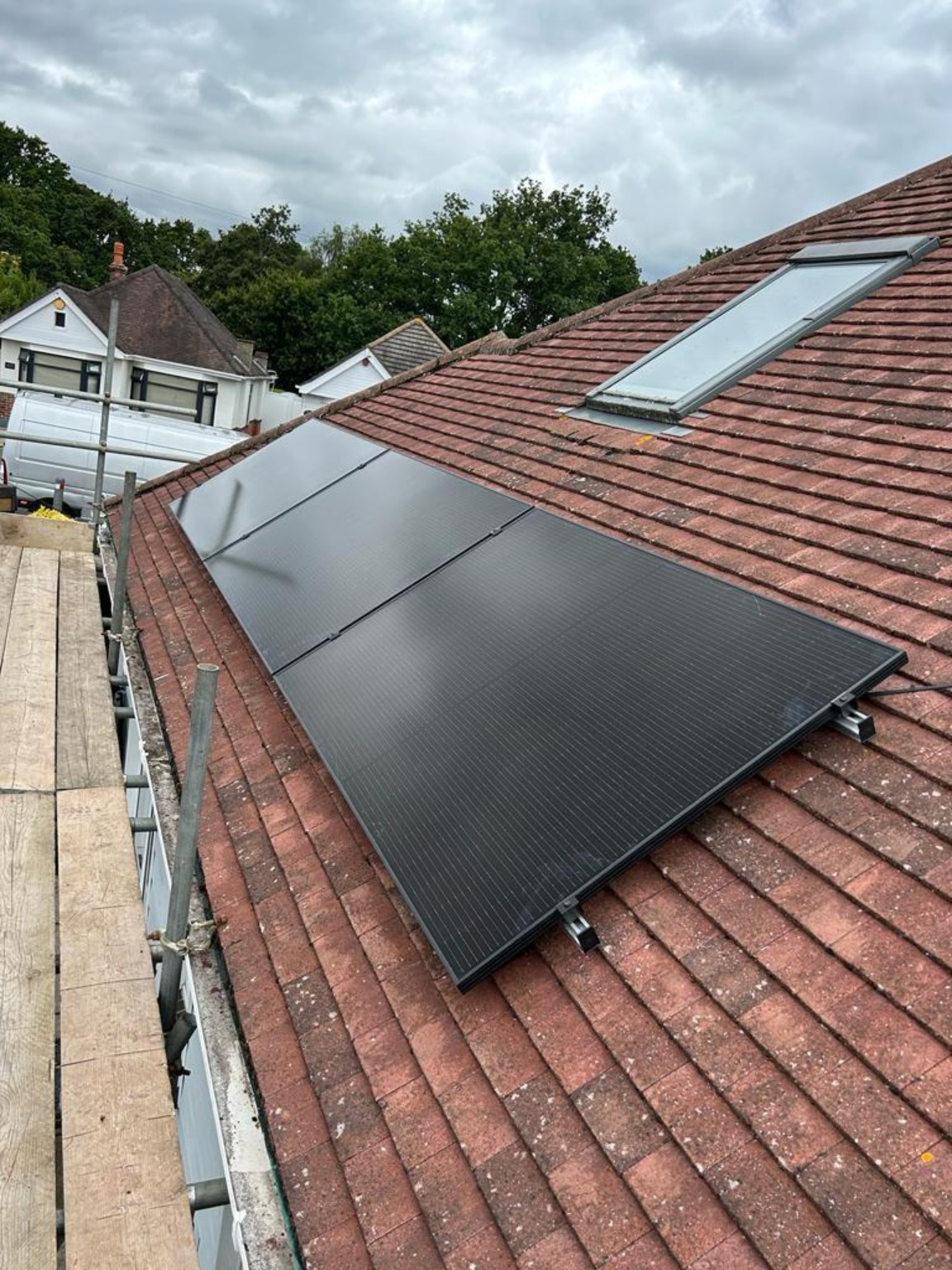 Roof-mounted solar beside a skylight