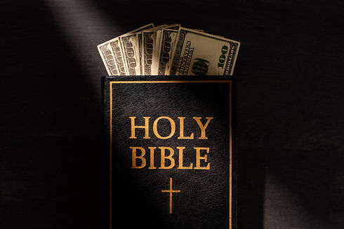 top-view-of-holy-bible-with-money-on-dark-backgrou-2024-11-17-11-28-55-utc.jpg