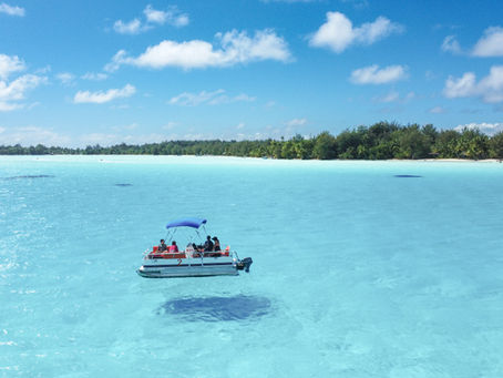 Boat floating in turquoise water in Bora Bora
