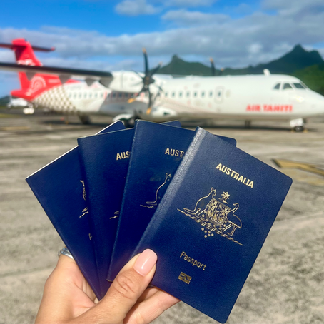 4 family passports being held in front of a Tahiti Air plane 