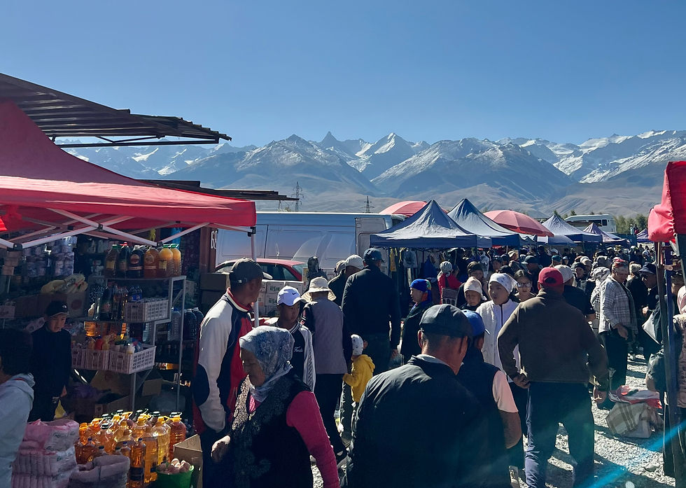 Busy Kyrgyzstan Markets beneath Snow capped mountains 