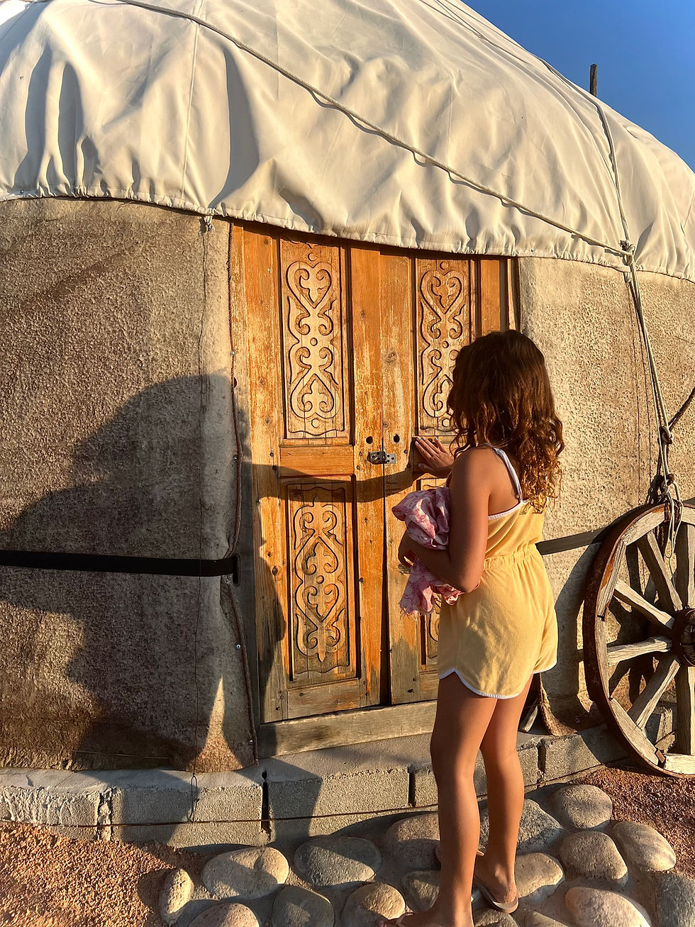 Little girl entering a yurt in Kyrgyzstan