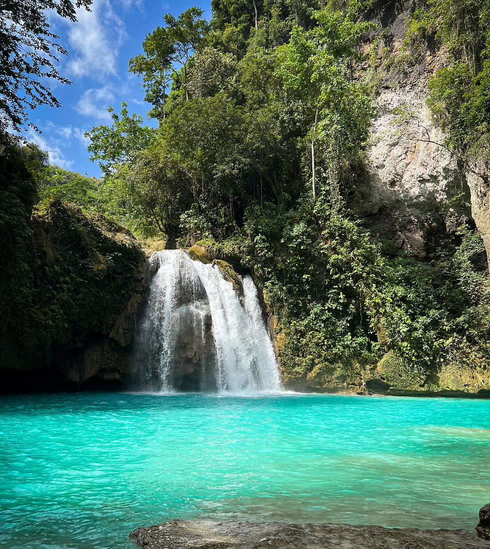 Turquoise waters of Kawasan Waterfall, rocks and rainforest