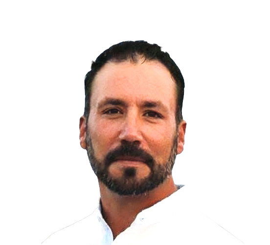 black hair dark olive skin mad with a beard wearing a white button up shirt