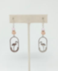 Handcrafted earrings with oval framed flamingo charm dangling from pink and peach crystals.