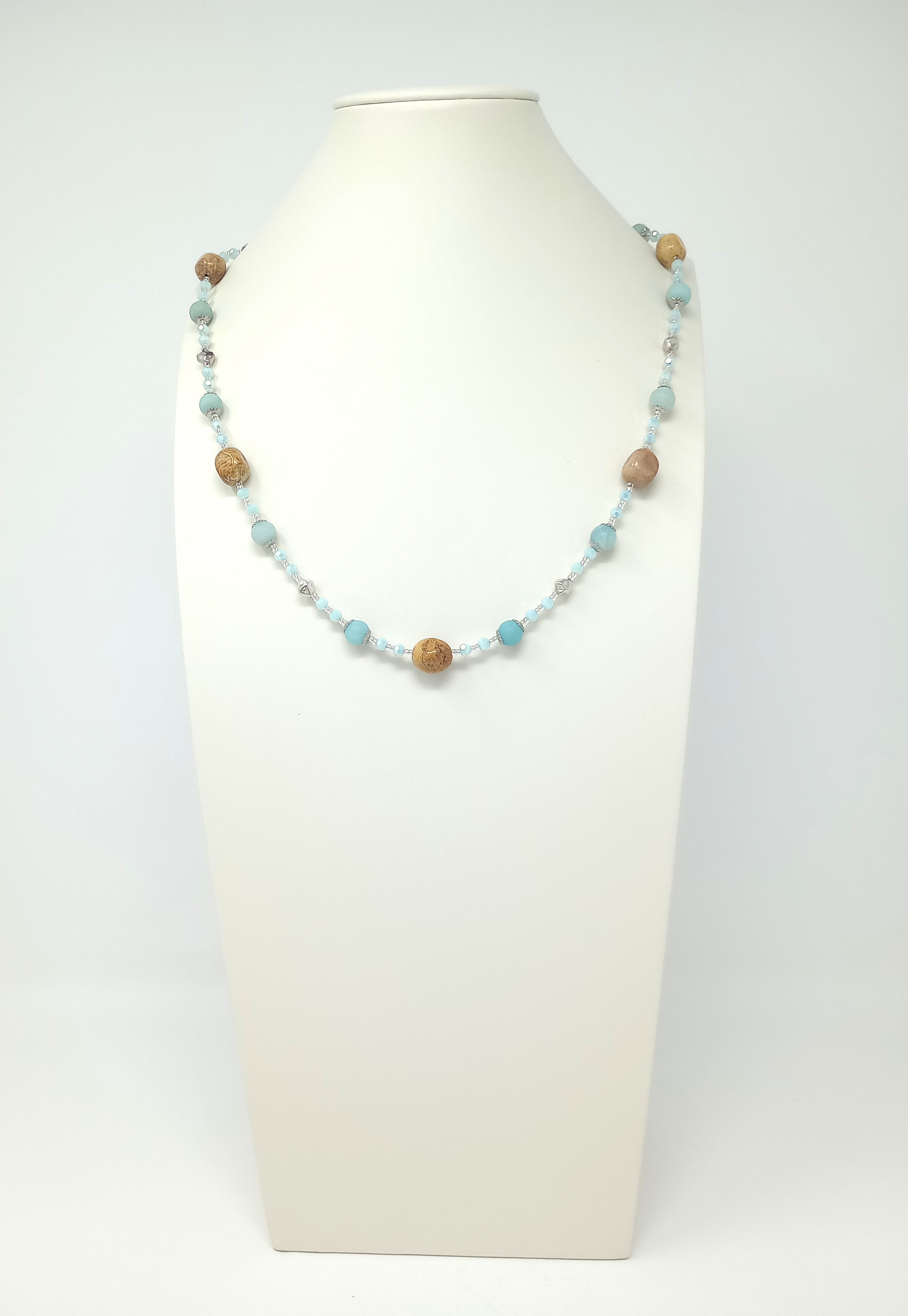 Handcrafted necklace of light blue amazonite and tan fossil coral gemstones, blue crystals and silver tone beads