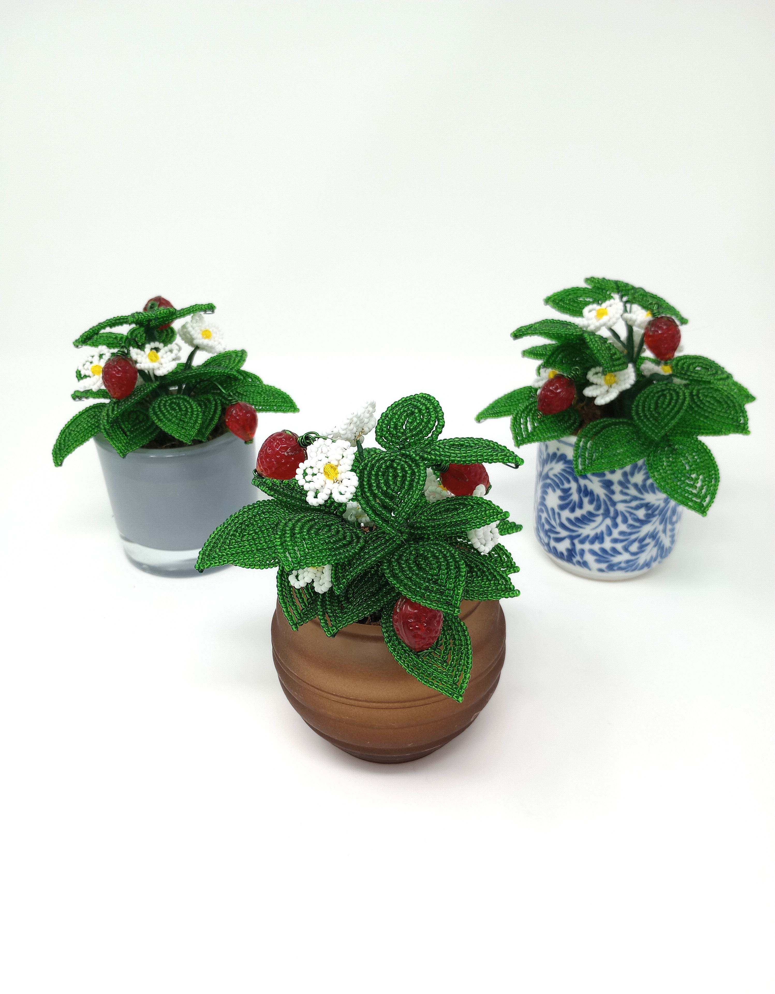 Handcrafted French beaded strawberry plants in pot: green leaves, white blossoms, red berries