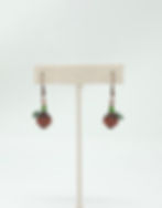 Handcrafted earrings : Czech pumpkin bead in burnt orange, green crystal stem and green wire coil.