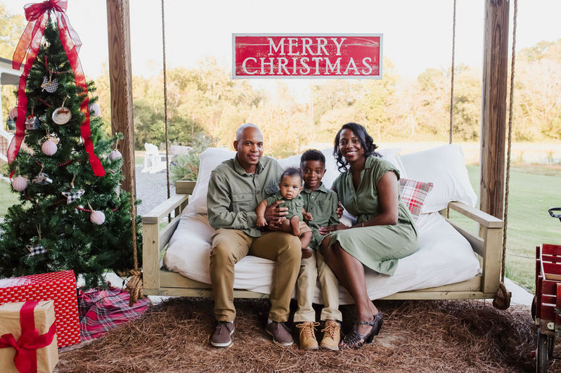 couch swing, decorative signs, Christmas trees, grassy field
