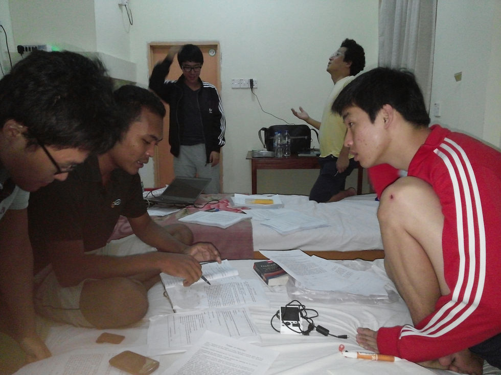 Translating the Korean power of attorney into English and then into Arakanese, the night before the meeting. KS and Youngmin are trying to fix the light at the accommodation and